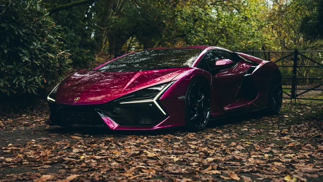 A red Lamborghini photographed against dark woodland