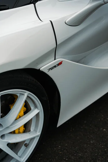 Close detail of a white McLaren wheel and bodywork