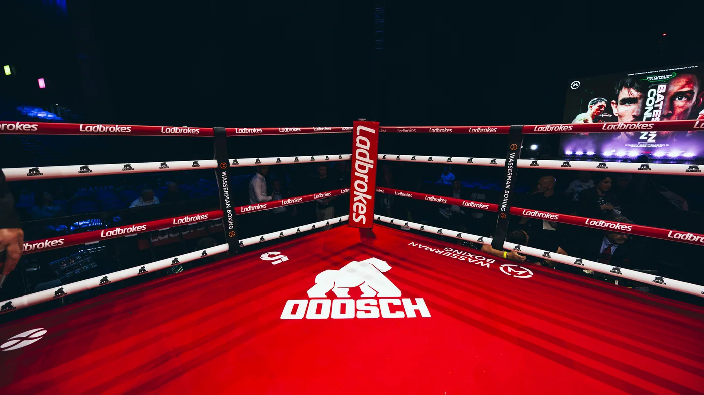A wide view of the red Ooosch-branded boxing ring at the 3Arena