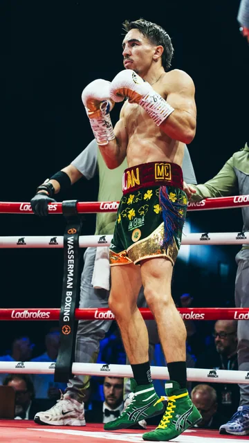 A boxer in his stance inside the ring