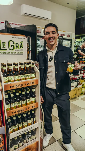 Brand ambassador beside a Le Grá display