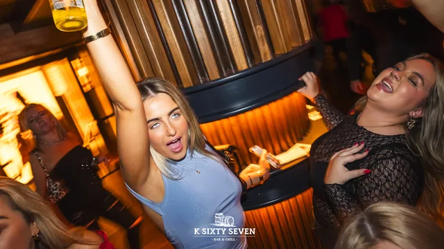 A candid nightlife moment under warm bar lighting