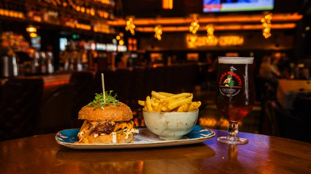 Burger, fries and a drink photographed in the bar