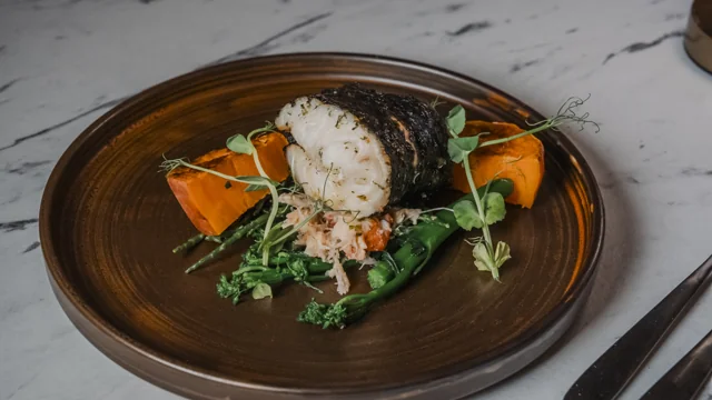A plated dish with vegetables and greens