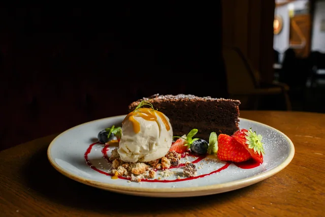 A dessert presented against a dark restaurant background