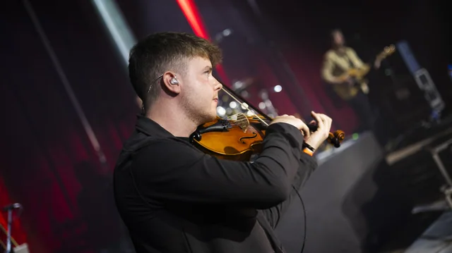 A violinist performing on stage