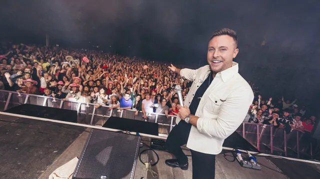 Nathan Carter in a white jacket with the Swords Castle audience behind him
