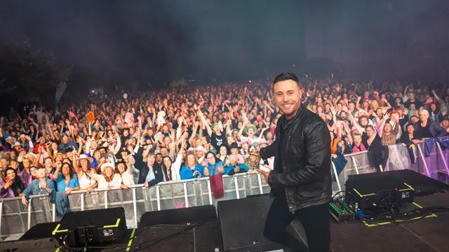 Nathan Carter on stage with a packed audience behind him