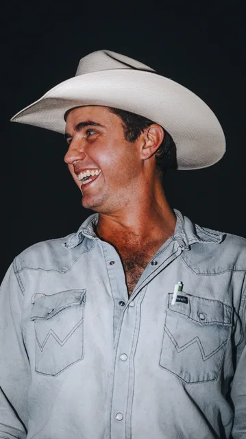 A portrait of a man wearing a white cowboy hat