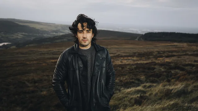 Jake Carter photographed against a mountain landscape