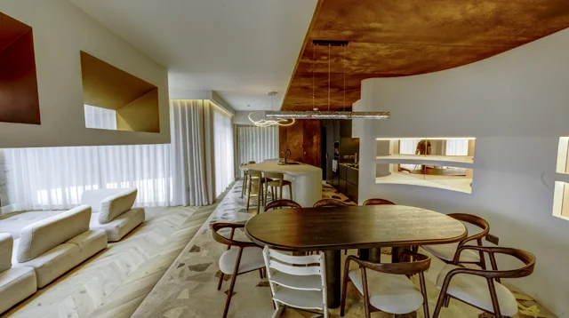 A bright dining and living space with curved architectural details