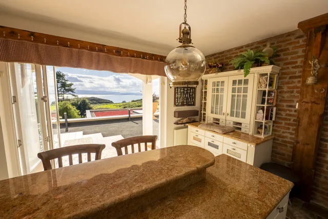 A bright kitchen opening onto a terrace and garden