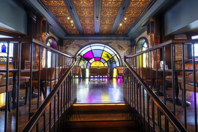 A symmetrical interior view towards a colourful window